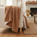 Caramel brown faux fur and ivory Caramel brown faux fur and ivory Sherpa throw blanket draped over a chair