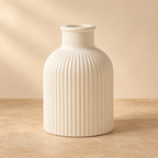 White ribbed gypsum bottle vase on a warm beige background
